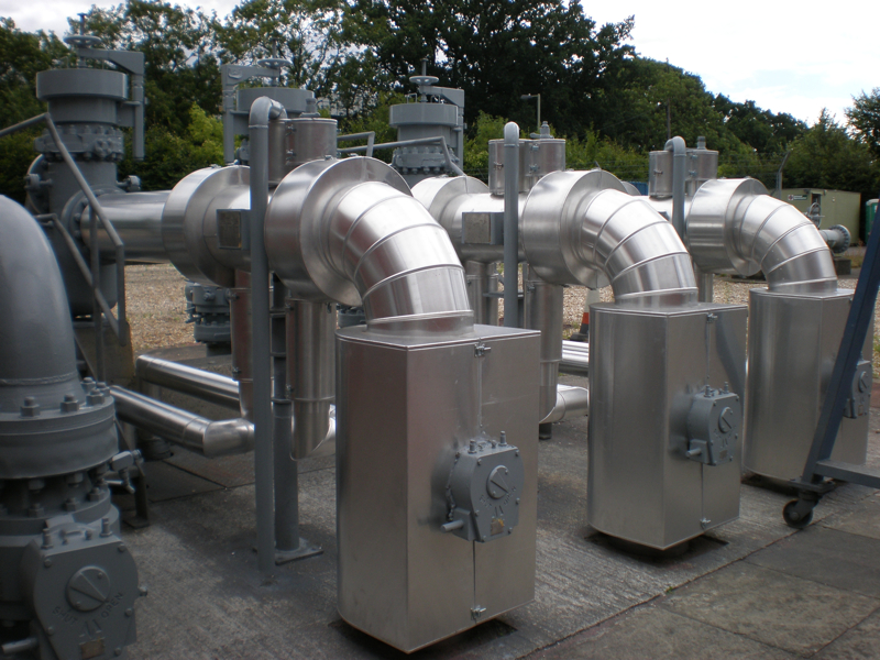 Large pipework and valves insulated with metal cladding. Heat loss surveys can identify hoe much energy this can save.