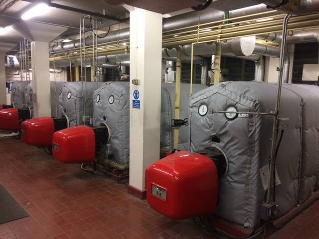 Thermal insulation jackets on tanks in a factory.